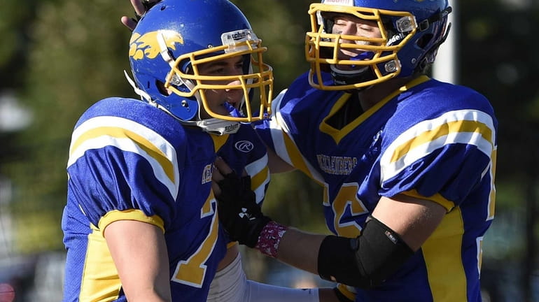 Kellenberg's Jason DeLucia, left, is congratulated by Peter Guariglia after...