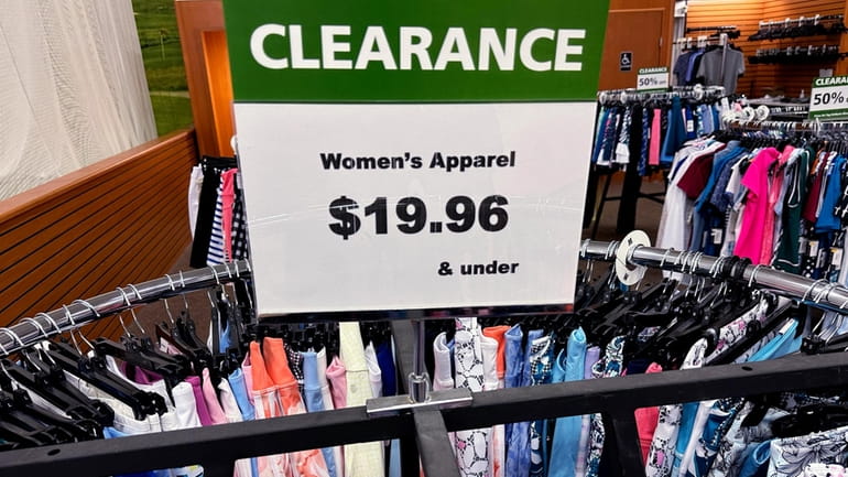 A clearance sign is displayed at a retail clothing store...