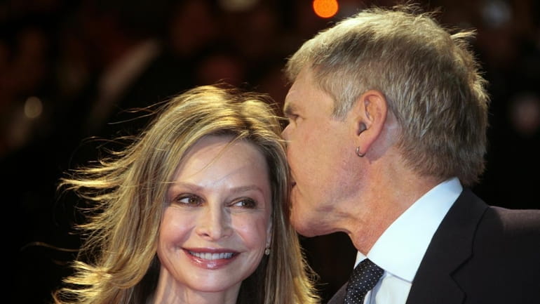 Harrison Ford posing with Calista Flockhart as they arrive to...