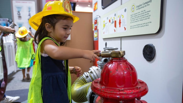 Sienna Cunsolo of Wantagh plays with a toy fire hydrant at...