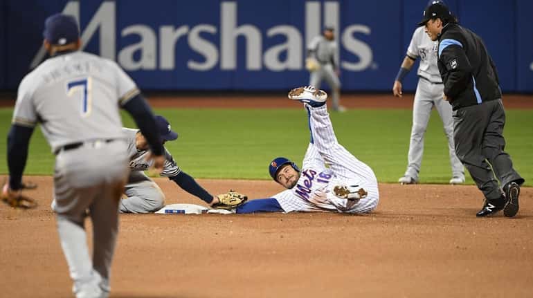 Milwaukee Brewers second baseman Mike Moustakas tags out Mets catcher...