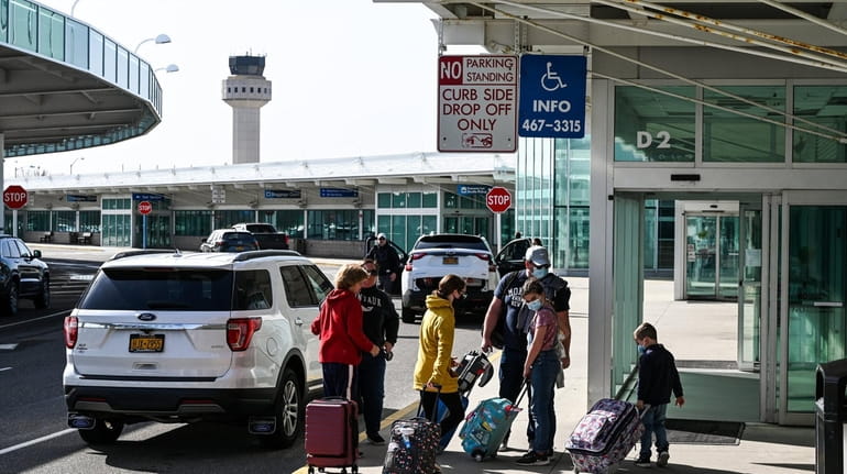 Passengers prepare for a flight outside the main terminal at...