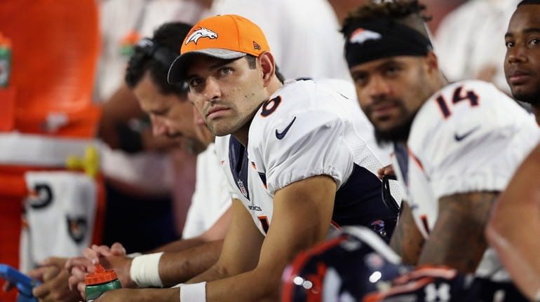 Quarterback Mark Sanchez #6 of the Denver Broncos watches from...