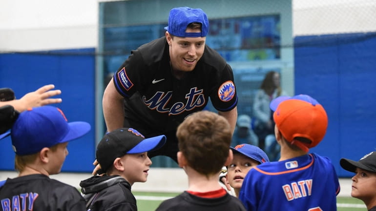 Mets third baseman Brett Baty chats with little leaguers during...
