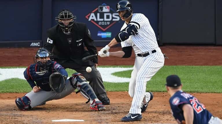New York Yankees' Giancarlo Stanton hits a sacrifice fly that...