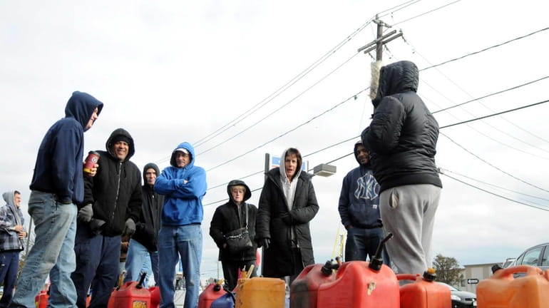 Gas customers brave the cold Monday as they wait on...