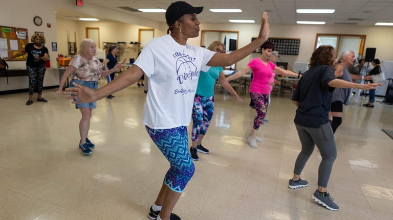 Yvonne Drain, 59, takes part in a Zumba class at...