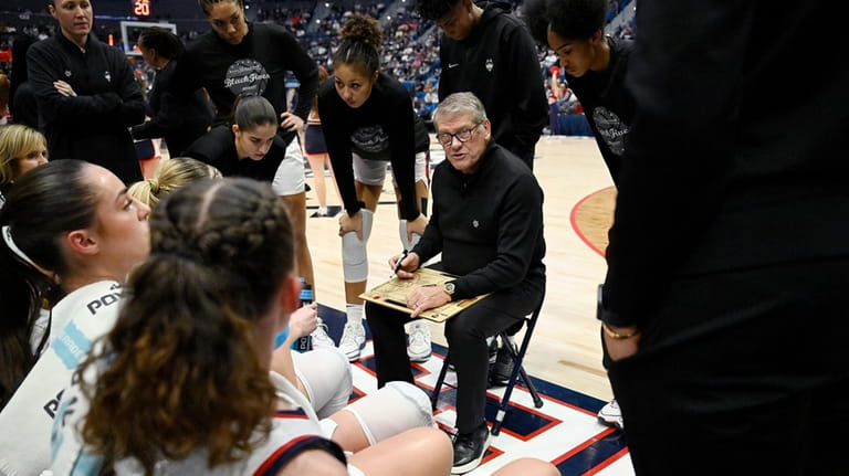 UConn head coach Geno Auriemma talks with his players during...