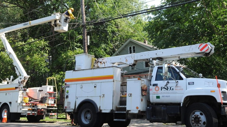 A PSEG Long Island utility worker works on restoring power...