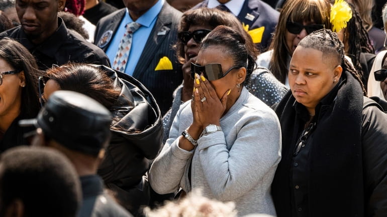 Mourners cry as Chicago Police Officer Aréanah Preston's hearse arrives...