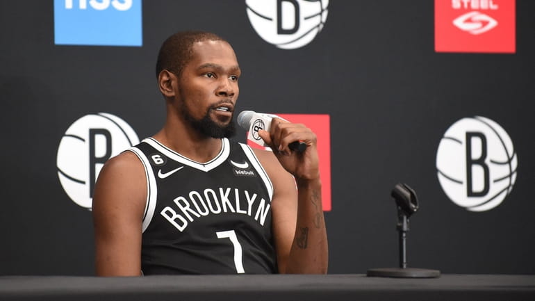 Kevin Durant #7 of the Brooklyn Nets fields questions from...