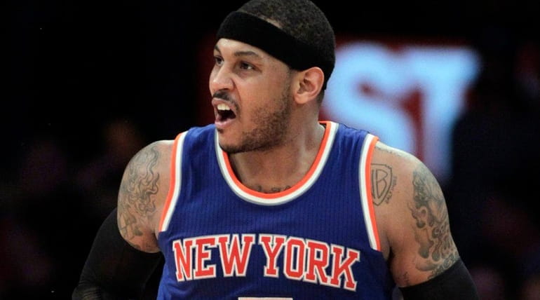 New York Knicks forward Carmelo Anthony reacts after making a...