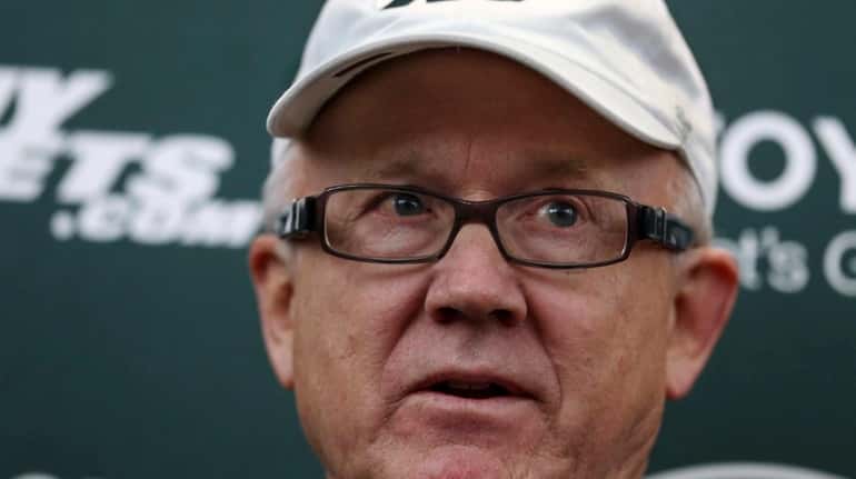 New York Jets owner Woody Johnson answers a question as...