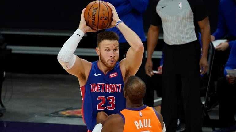 Pistons forward Blake Griffin looks to pass over Suns guard Chris...
