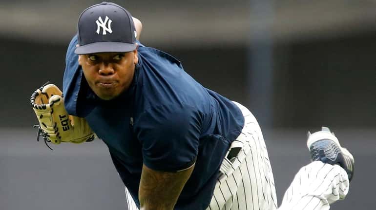 Yankees pitcher Aroldis Chapman throws on the field prior to a game...