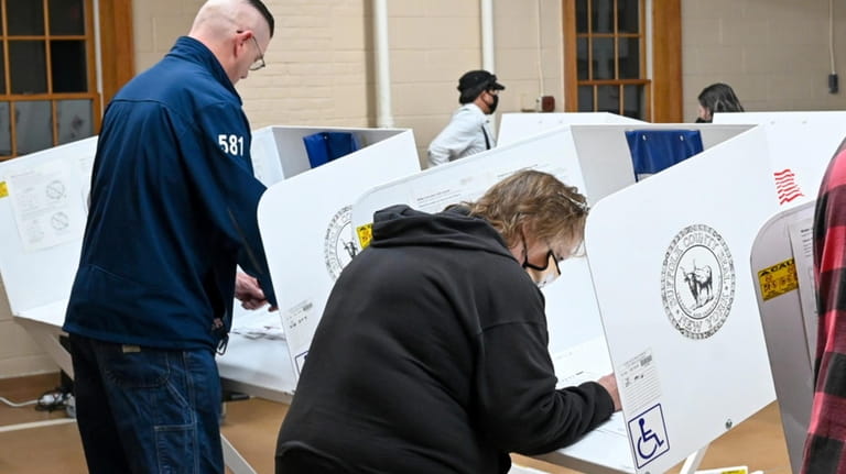 Voters fill out their ballots at the Mastic Beach Fire...