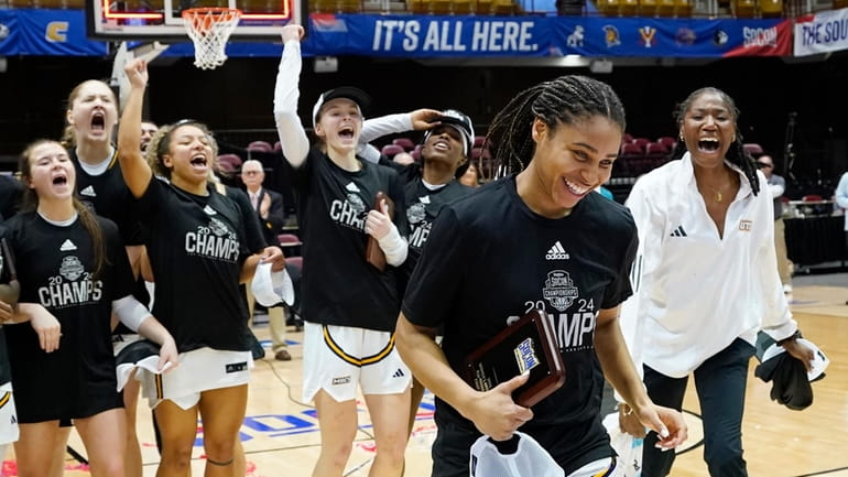 Chattanooga guard Jada Guinn is cheered by teammates as she...
