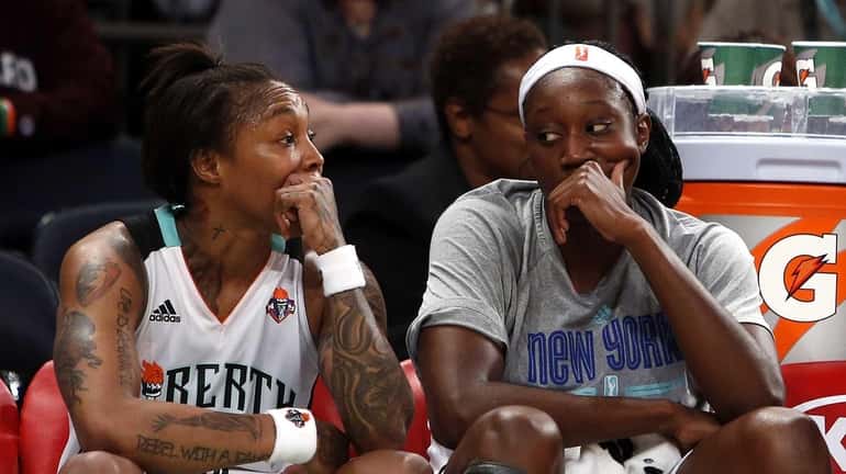 The Liberty's Cappie Pondexter, left, and Tina Charles sit on...