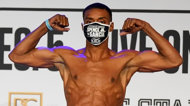 Errol Spence Jr., poses as he weighs in for a...