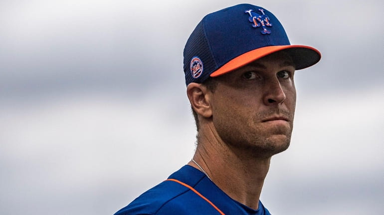 The Mets' Jacob deGrom looks on during a spring training...