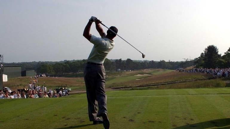 Tiger Woods tees off at the 14th tee at the...