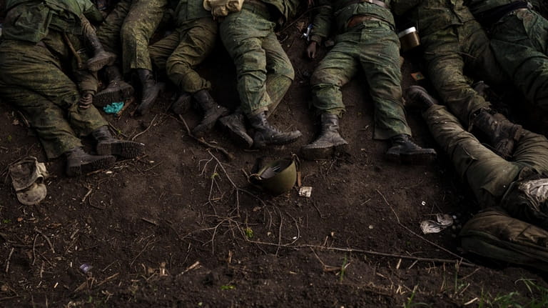 The bodies of 11 Russian soldiers lie on the ground...