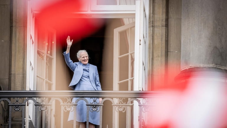 Denmark's Queen Margrethe II waves from the balcony during celebrations...