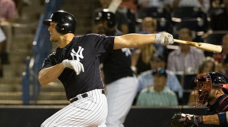 New York Yankees' Matt Holliday follows through on a double...