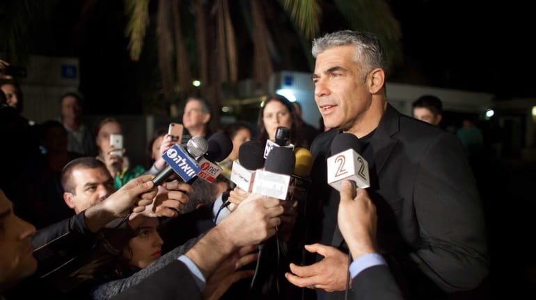 Yair Lapid, leader of the Yesh Atid party, speaks to...