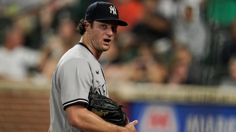 Yankees starting pitcher Gerrit Cole talks to himself while heading...