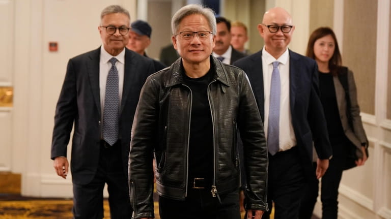 Nvidia CEO and co-founder Jensen Huang, center, arrives for a...