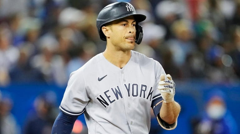 Giancarlo Stanton of the Yankees flips the bat after hitting...
