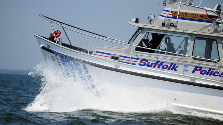 A Suffolk County Police Marine Bureau police boat cuts through...