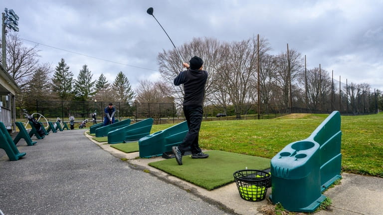 Golf enthusiasts practice their skills at the Town of Oyster...