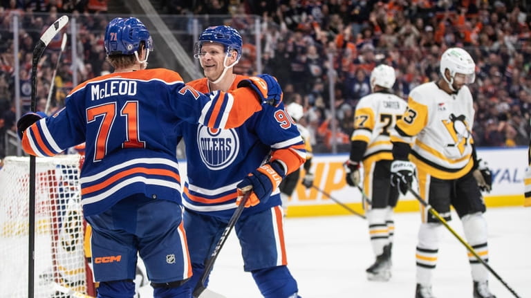 Edmonton Oilers' Ryan McLeod (71) and Corey Perry celebrate a...