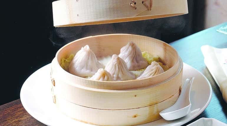 Juicy soup dumplings filled with pork and gingery sauce are...