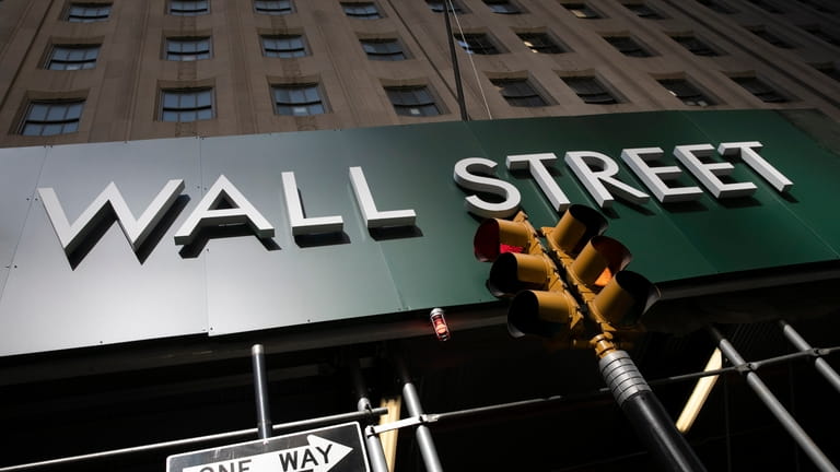 A sign for a Wall Street building is shown, Tuesday,...