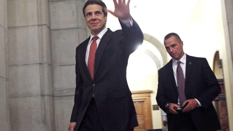 New York Gov. Andrew Cuomo waves as he leaves the...
