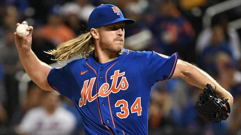 Mets pitcher Noah Syndergaard delivers against the Marlins during the...