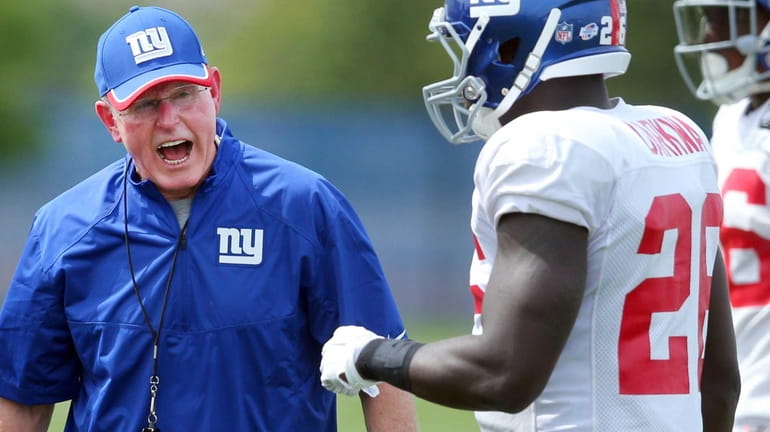 New York Giants head coach Tom Coughlin yells at running...
