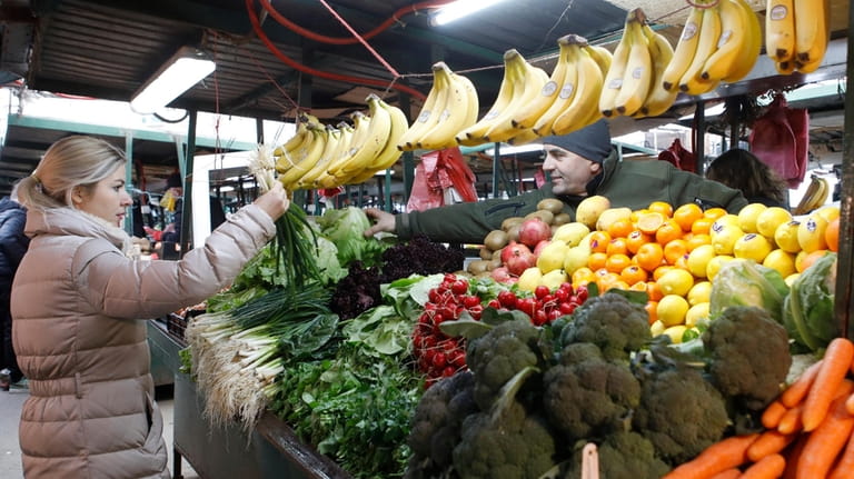 A woman shops at a market in Skopje, North Macedonia,...