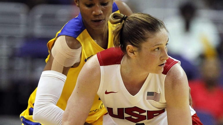 Team USA guard Lindsay Whalen, front, looks to pass around...