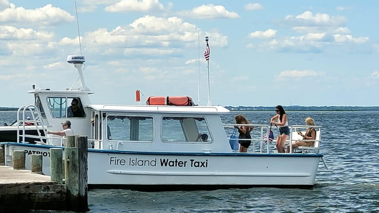 Visitors grab a Fire Island Water Taxi in Ocean Beach.