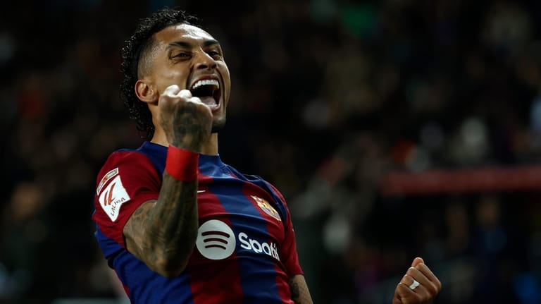 Barcelona's Raphinha celebrates after scoring his side's opening goal during...