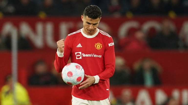FILE - Manchester United's Cristiano Ronaldo holds the ball after...