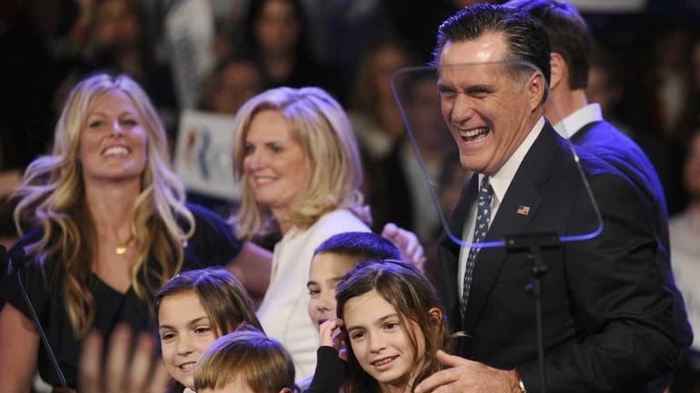 Republican presidential hopeful Mitt Romney celebrates with family during a...