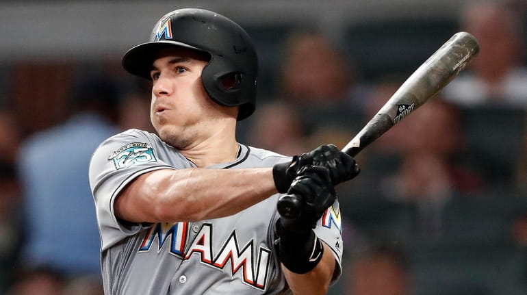 Marlins catcher J.T. Realmuto follows through on two-run base hit in...