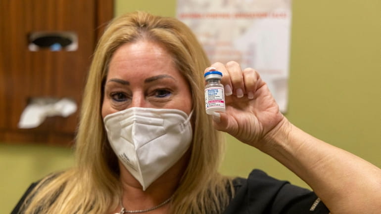 Dr. Lori Berman holds a vial of the Moderna COVID-19 vaccine for...