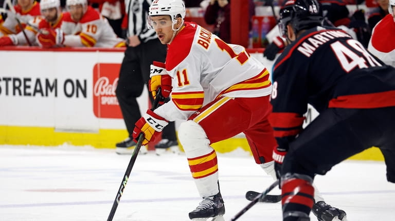Calgary Flames' Mikael Backlund (11) controls the puck in front...