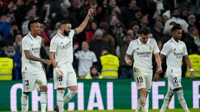 Real Madrid's Karim Benzema, second left, celebrates with teammates after...